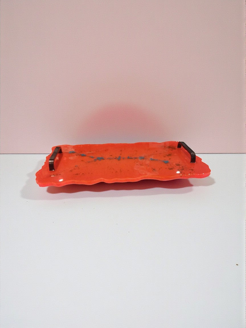 Artymunk3y orange resin serving tray with black handles and turquoise flecks. Irregular edge design.
