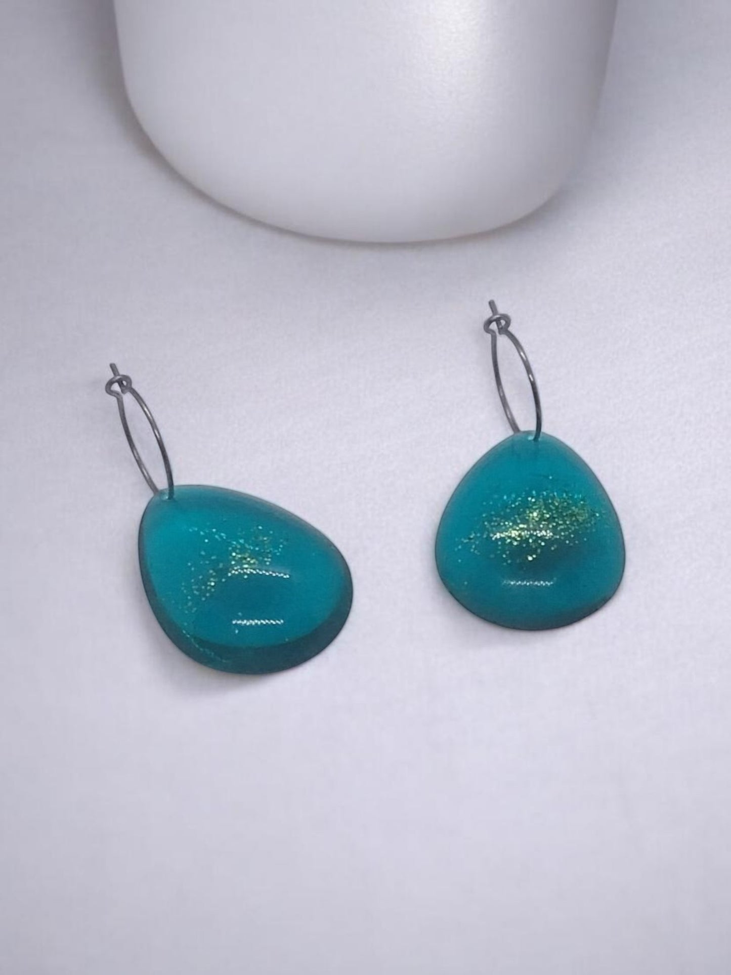 Artymunk3y teal teardrop hoop earrings with gold glitter flecks and silver-tone hoops.