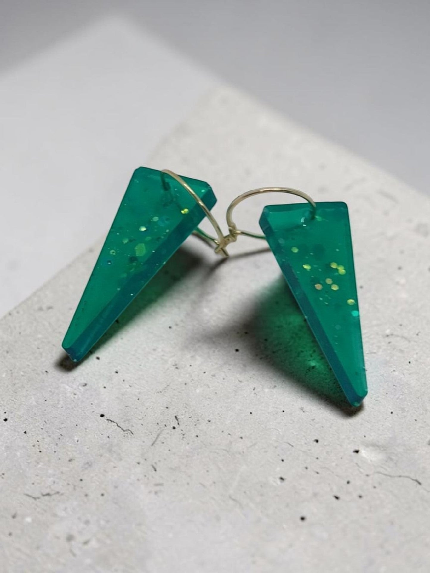 Artymunk3y teal glitter triangle dangle earrings made of resin with hypoallergenic hooks.