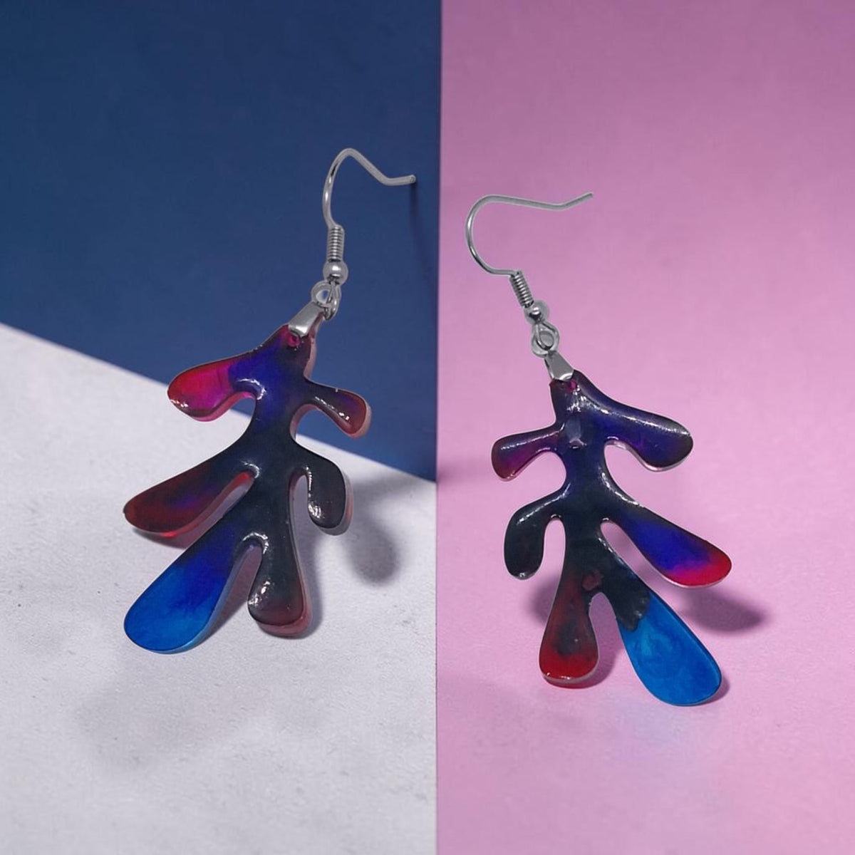 Artymunk3y abstract resin drop earrings with organic leaf shapes in gradient red, blue, and violet on silver hooks.