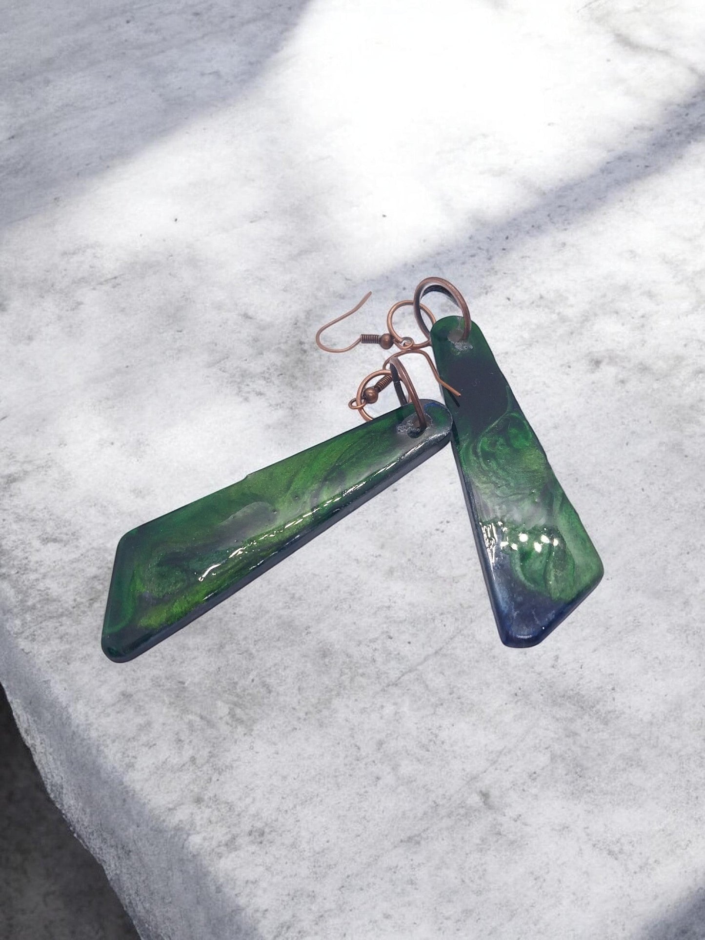 Artymunk3y Abstract Swirl Dangle Earrings in deep green with glossy finish and copper-toned ear wires.