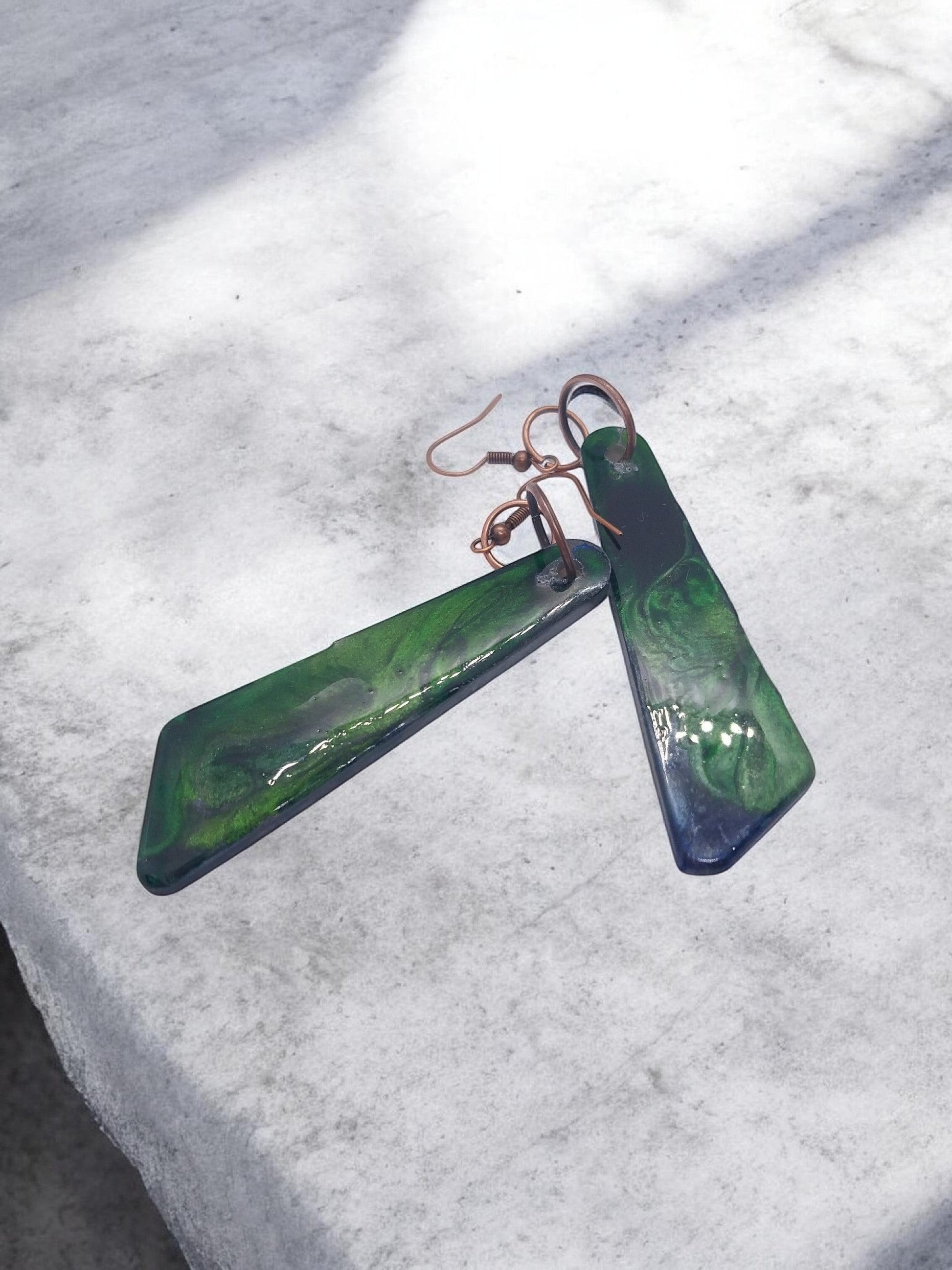 Artymunk3y Abstract Swirl Dangle Earrings in deep green with glossy finish and copper-toned ear wires.