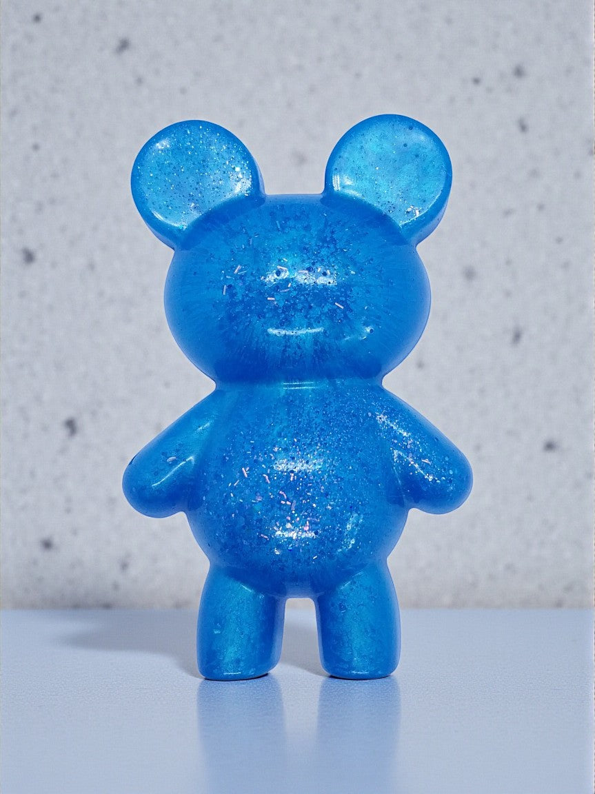 Artymunk3y blue glitter bear figurine made of resin. Translucent blue with embedded glitter for sparkle.