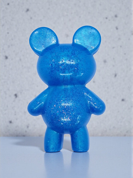 Artymunk3y blue glitter bear figurine made of resin. Translucent blue with embedded glitter for sparkle.