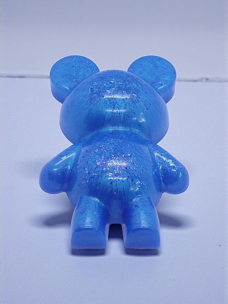 Artymunk3y blue glitter bear figurine made of resin. Translucent blue with embedded glitter.