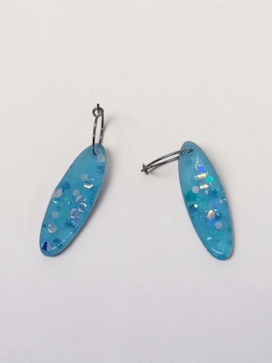 Artymunk3y sky blue oval resin dangle earrings with iridescent glitter and confetti.