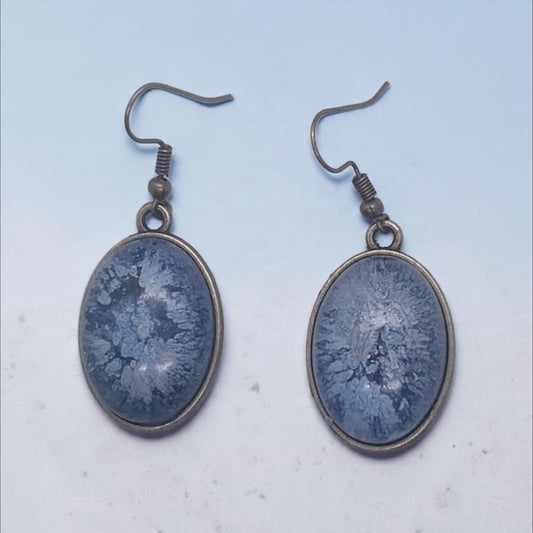 Artymunk3y oval drop earrings featuring blue frost-patterned resin in antique-bronze frames with hook backings.