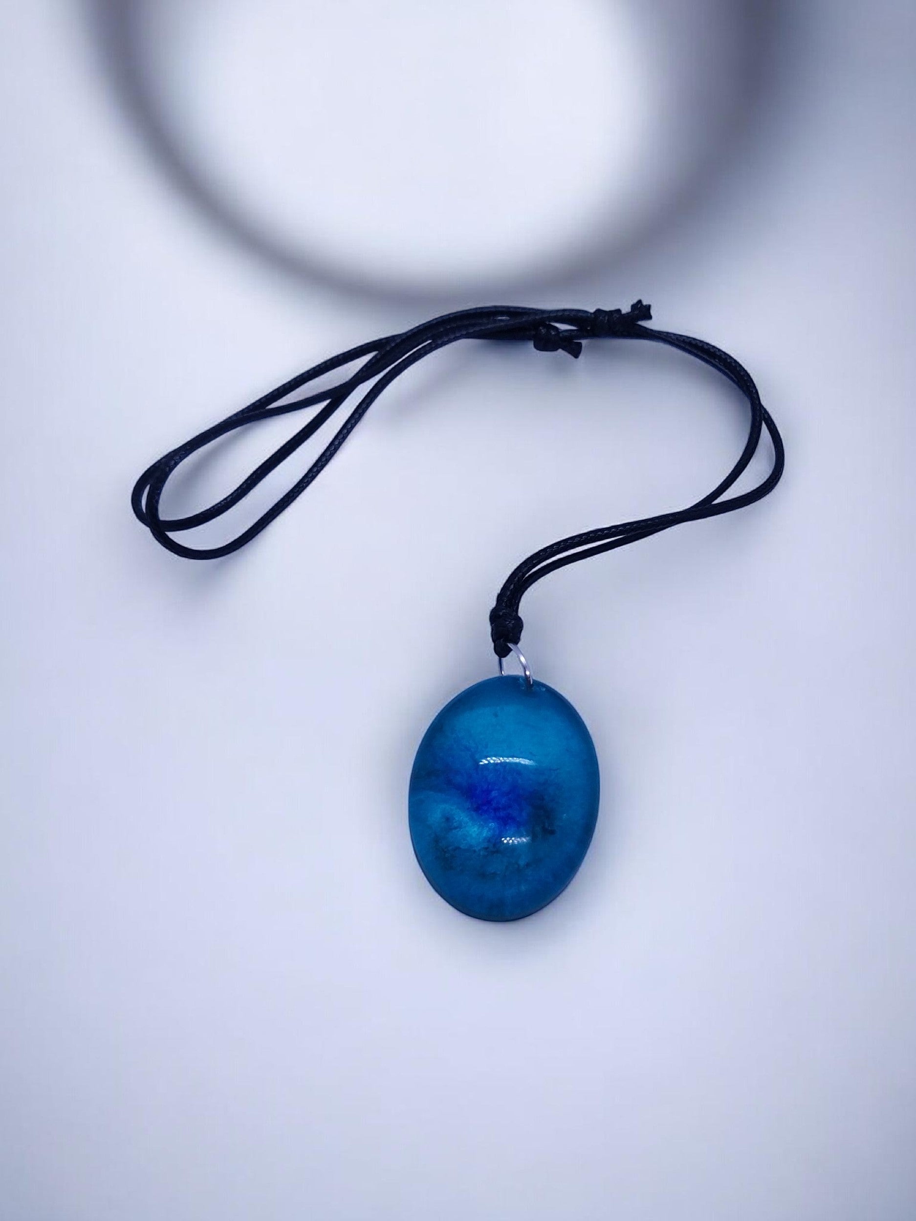 Artymunk3y blue resin oval pendant necklace with adjustable black cord, ocean swirl design