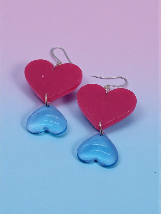 Artymunk3y Double Heart Dangle Earrings: red heart above translucent blue heart, silver-toned hooks.