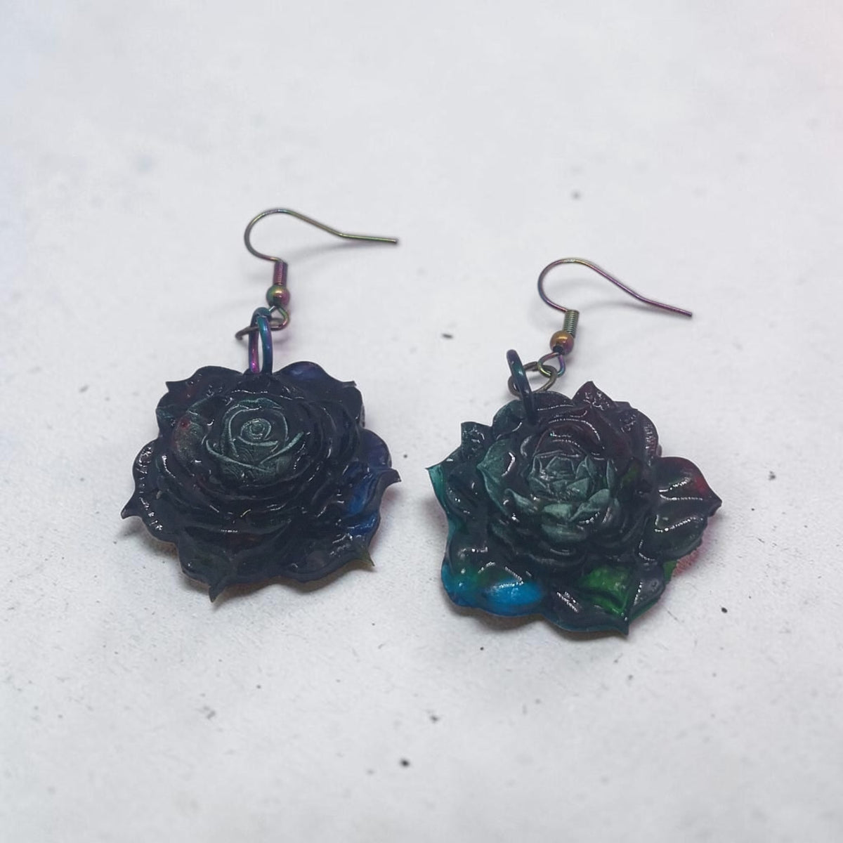 Artymunk3y handcrafted floral rose drop earrings in moody midnight blue, forest green, and violet with iridescent sheen
