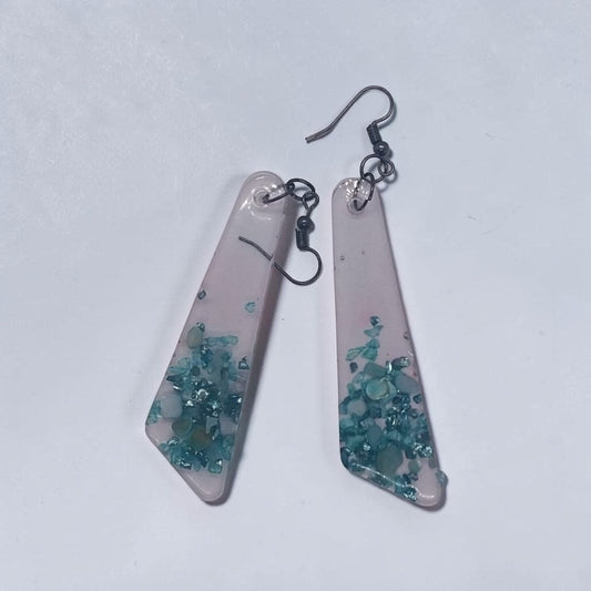 Artymunk3y geometric resin dangle earrings with translucent frosted finish and embedded teal turquoise stone chips.