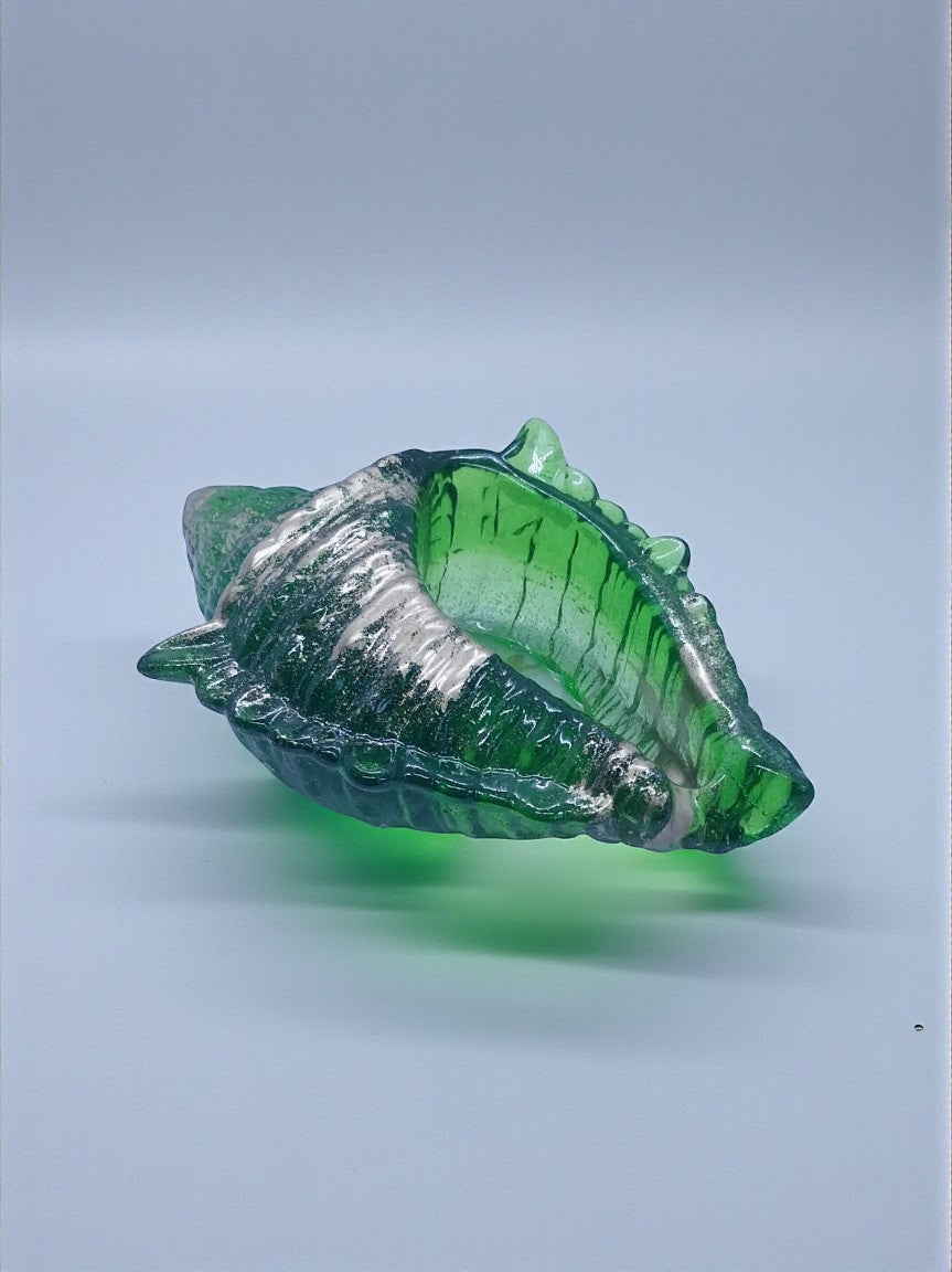 Artymunk3y green glass seashell sculpture with silver accents, detailed and translucent.