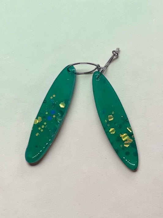 Artymunk3y green resin teardrop earrings with gold, yellow, and blue glitter accents.
