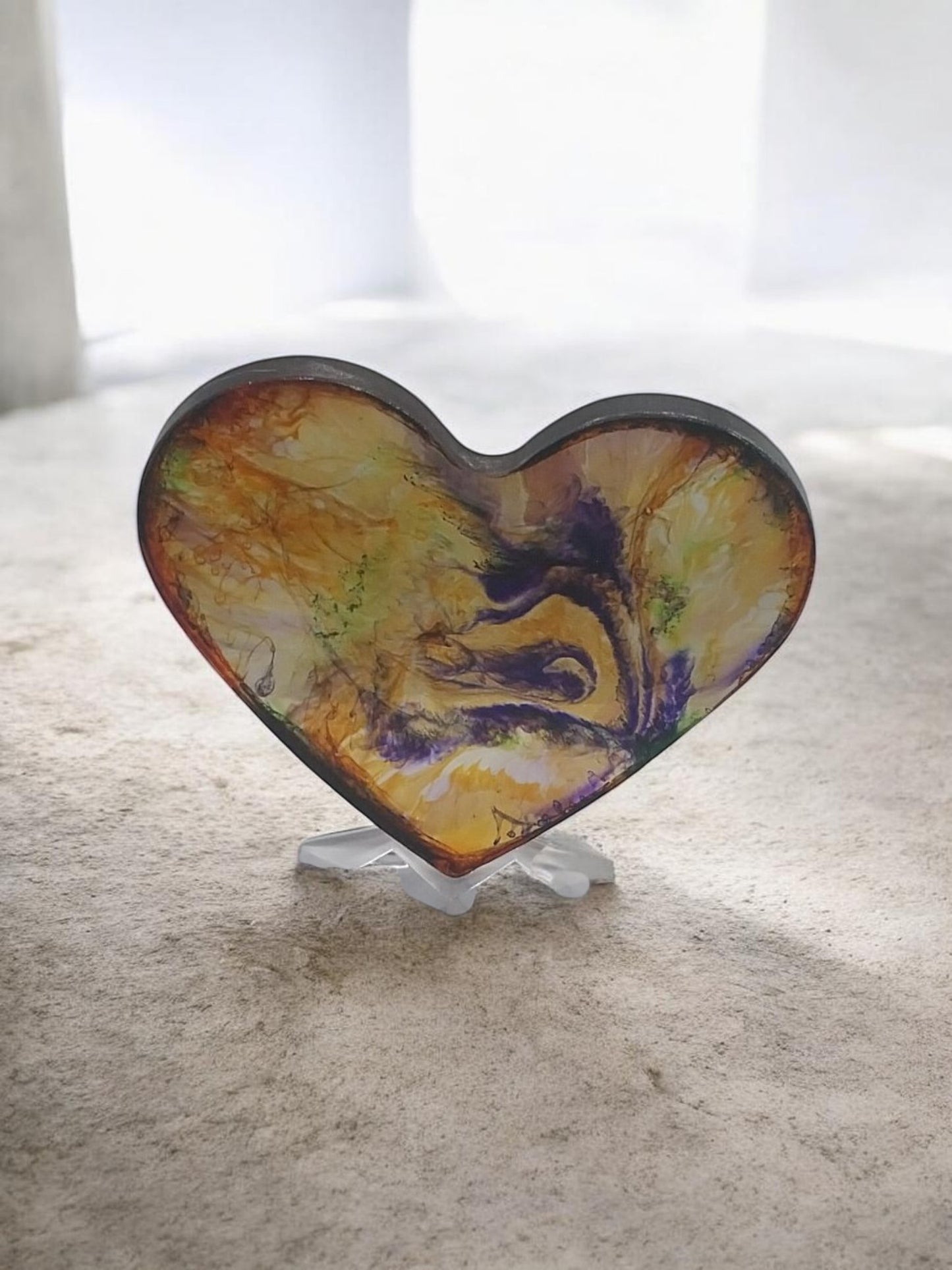 Artymunk3y heart shaped resin display with abstract yellow, orange, purple, and green swirls. Glossy finish.
