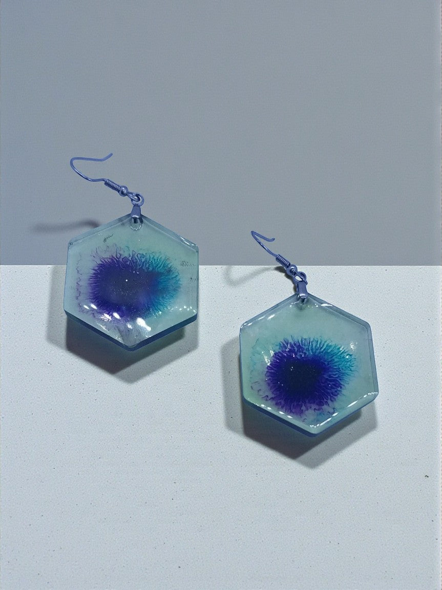 Artymunk3y hexagonal resin dangle earrings with abstract blue and purple swirls. Lightweight, clear resin with hook closure.