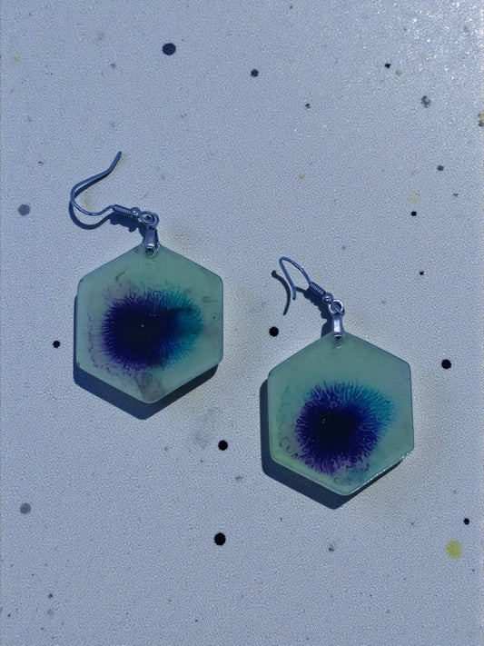 Artymunk3y hexagonal resin dangle earrings with abstract blue and purple swirls. Lightweight, clear resin with hook closure.