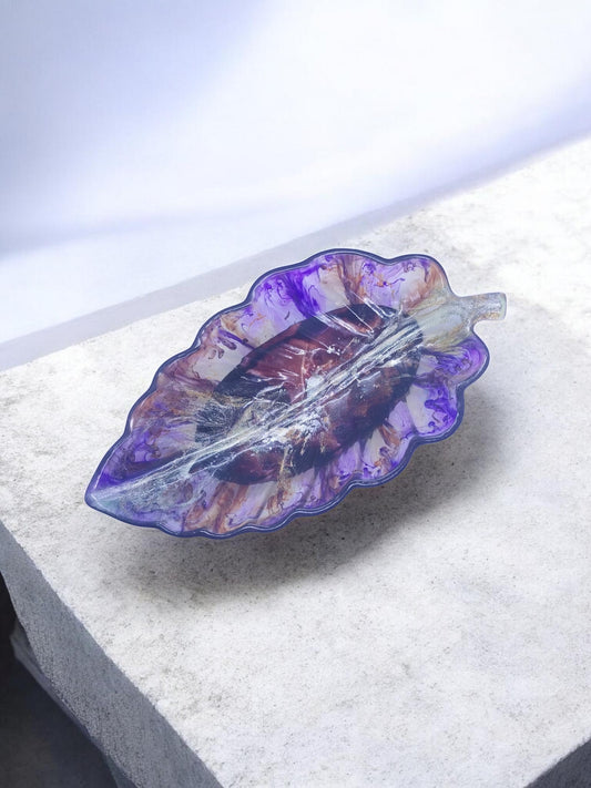 Artymunk3y leaf shaped decorative tray in purple, white, and gold marbled resin. Features a glossy finish and stem detail.