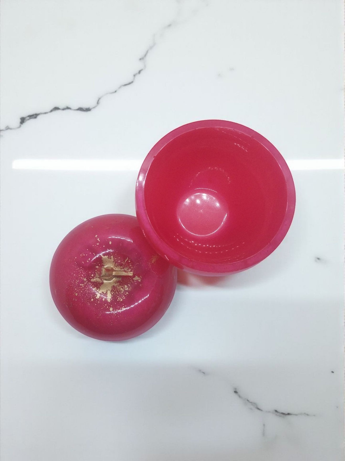 Artymunk3y pink apple-shaped trinket box with gold flecks and stem detail. Hinged lid opens to reveal interior.