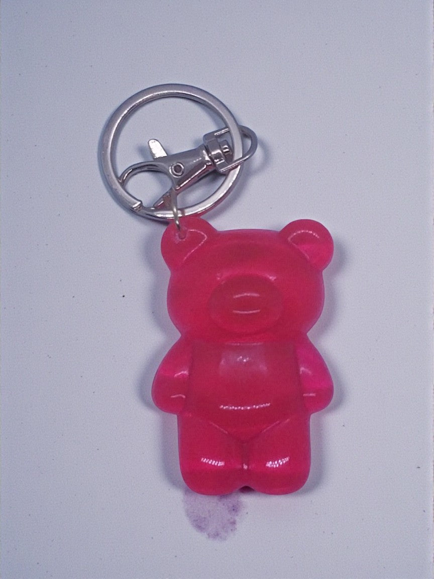 Artymunk3y pink translucent resin gummy bear keychain accessory with silver keyring.