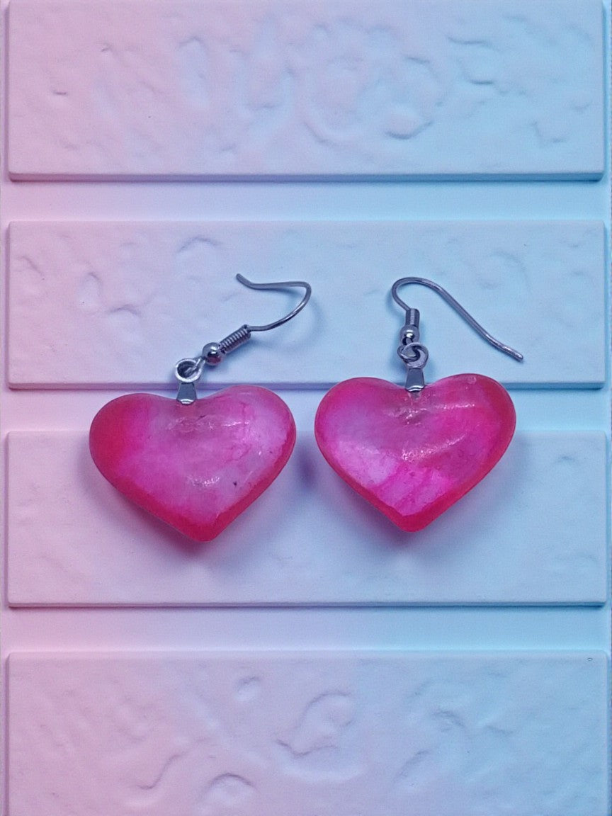Artymunk3y gradient pink heart dangle earrings with glossy finish and silver hooks.