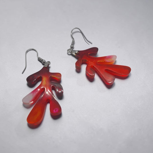 Artymunk3y organic drop earrings in translucent red and orange resin with a coral-like shape and silver-toned hooks.