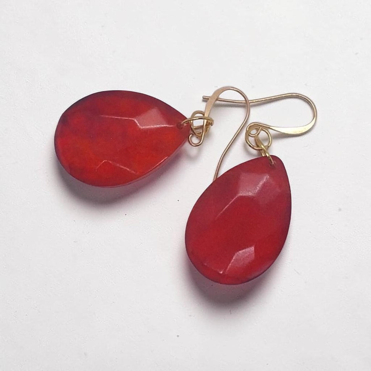 Artymunk3y faceted red teardrop dangle earrings with gold-tone hooks on a white background
