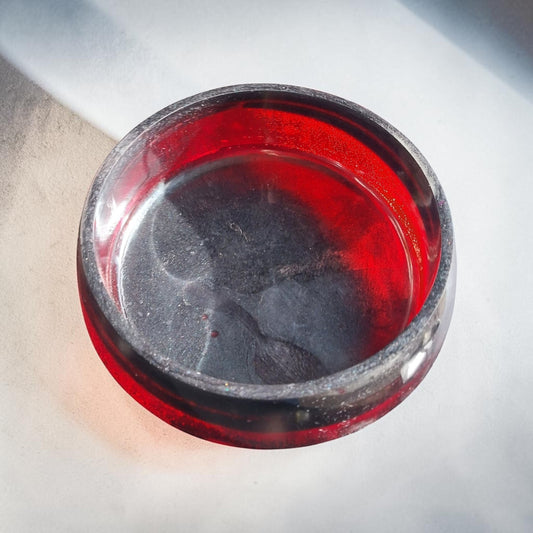 Artymunk3y handcrafted resin bowl in translucent ruby red and opaque black, featuring a smooth polished finish.