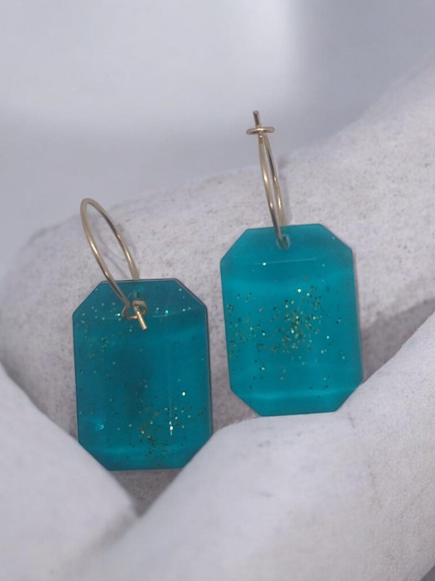 Artymunk3y teal octagonal gemstone hoop earrings with gold glitter accents and gold-tone hoops.
