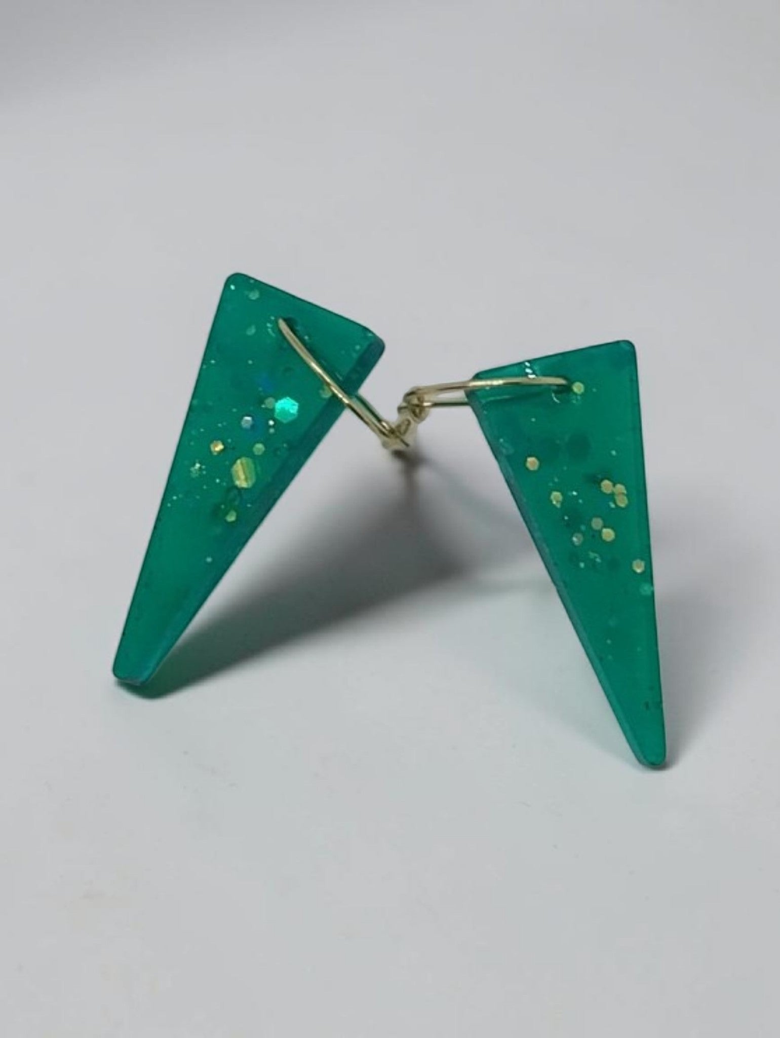 Artymunk3y Teal Glitter Triangle Dangle Earrings with gold hooks. Modern geometric resin earrings with fine and chunky glitter.