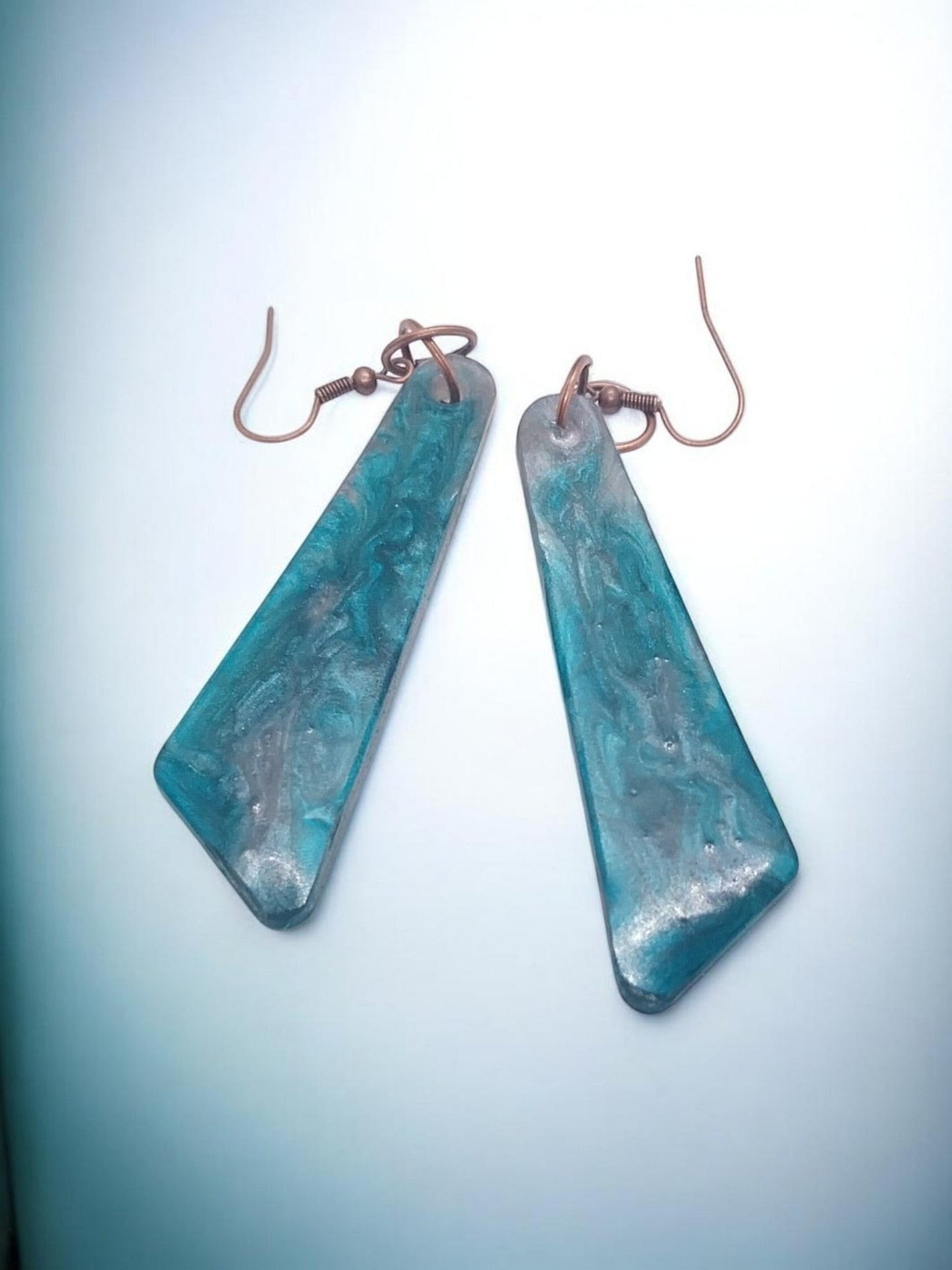 Artymunk3y Teal Swirl Resin Drop Earrings with copper-toned ear wires. Geometric shape, glossy finish.