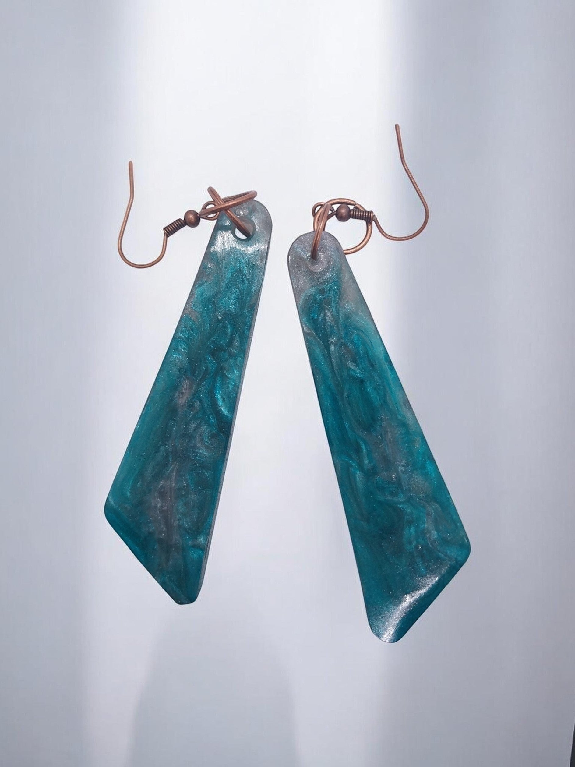 Artymunk3y Teal Swirl Resin Drop Earrings with geometric shape and copper-toned ear wires.