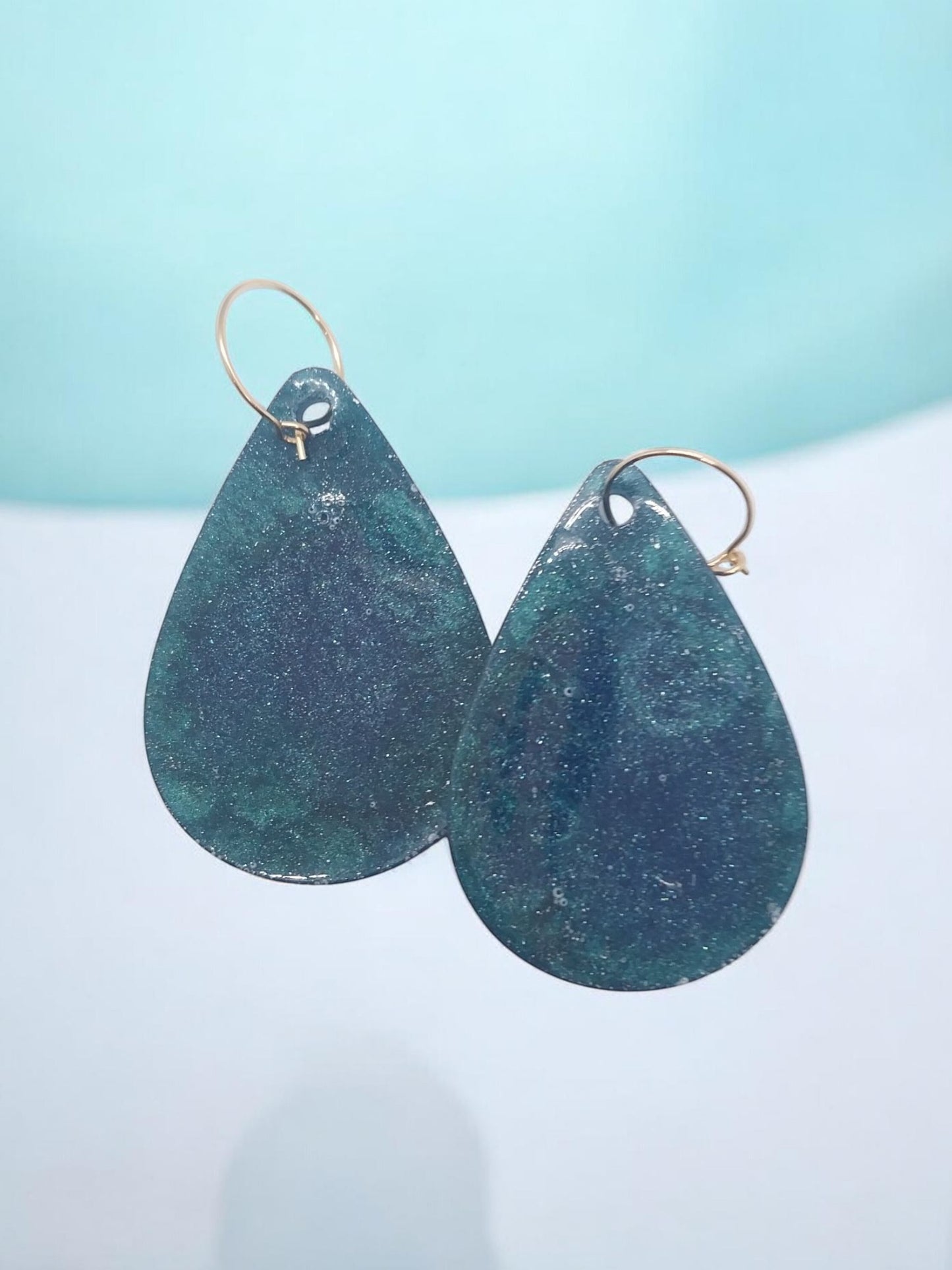 Artymunk3y teardrop dangle earrings in deep blue and green with gold hooks. Shimmering marbled effect.
