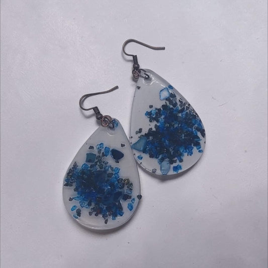 Artymunk3y teardrop resin dangle earrings with deep blue crushed stone accents and rustic metal hooks.